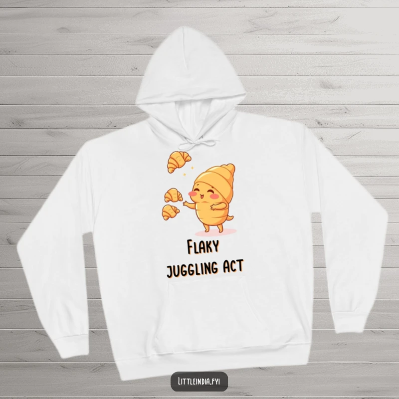 Funny blushing croissant character juggling tiny croissants, looking shy, printed on a soft, warm hoodie.
