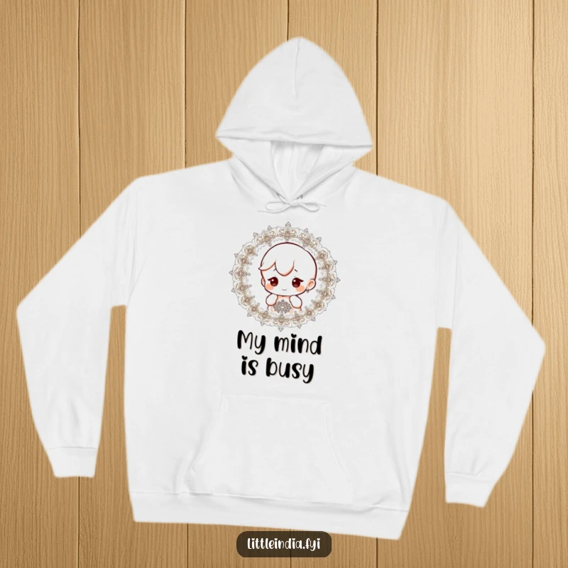 Funny hoodie with a small character showing a curious expression while observing detailed and intricate patterns.
