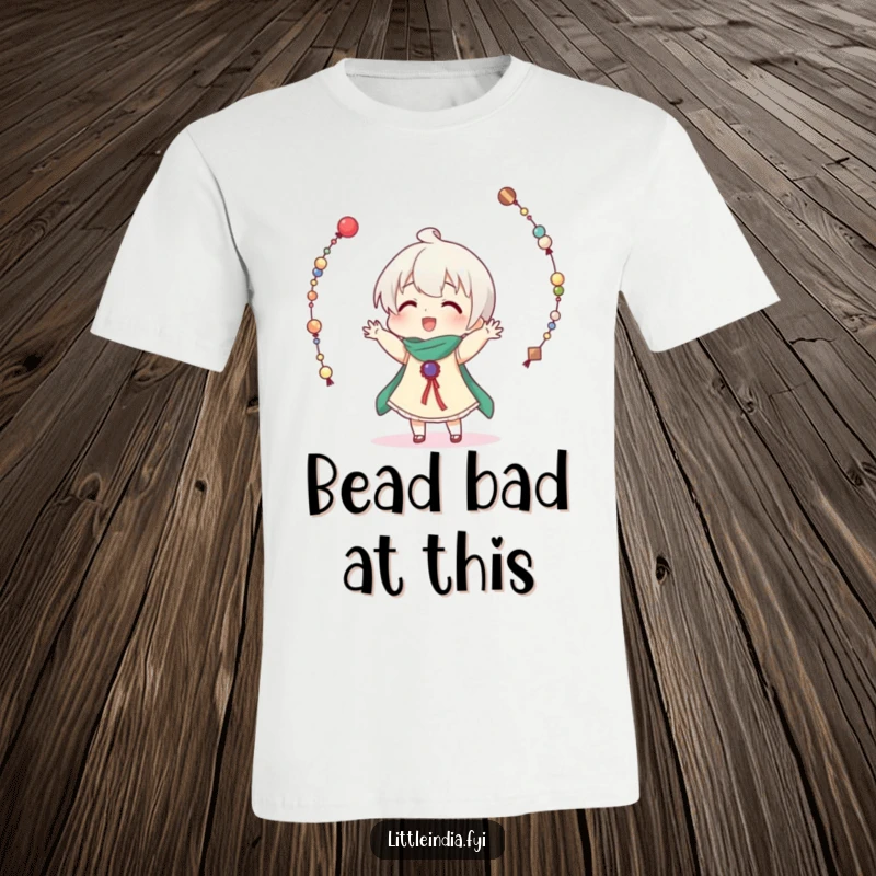 Funny t-shirt showcasing a character comically failing to juggle many strings of decorative beads, with beads flying everywhere.